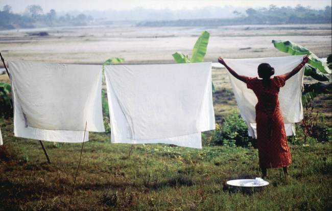 Nepali Woman Hanging Sheets to Dry by Flickr User Matthew Ramsey, CC License = Attribution