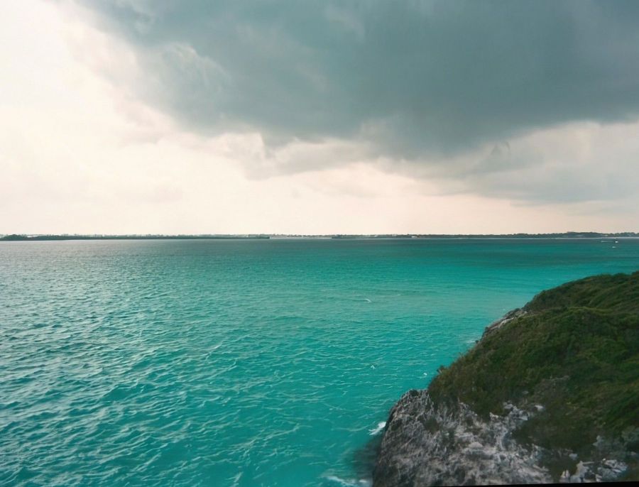 A stunning view of brilliant turquoise water and a tranquil tropical shoreline at Blue Lagoon in Nassau, Bahamas. Taken February 2004 with a disposable point and shoot camera.